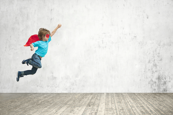 Superhero boy in flying through air