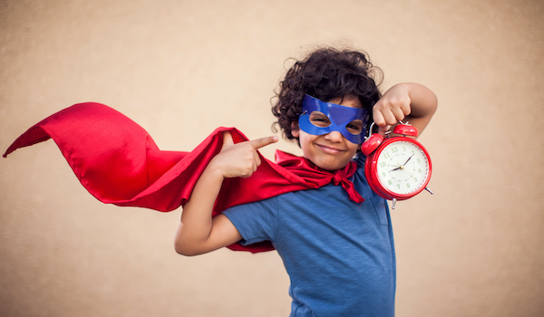 Superhero boy pointing to clock showing time savings with payroll bureau software