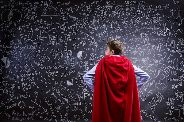 Superhero boy at blackboard with equations showing payroll software features and capabilities