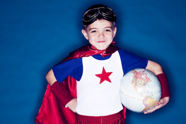 Superhero boy holding globe representing international payroll software capabilities across Africa